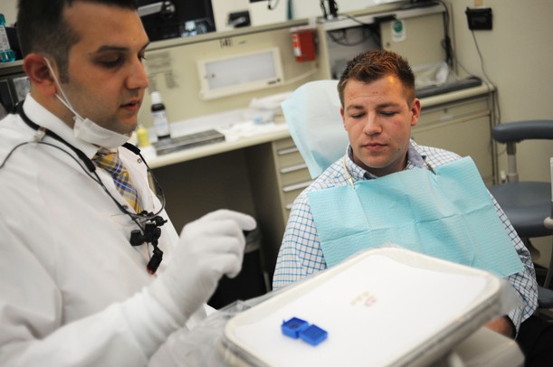 Dr. Chady A. Elhage speaks with patient Jean-Claude Soloman, 24, as they get started with his appointment on Thursday afternoon at the Graduate Prosthedontics clinic at the U-M Dental School. Melanie Maxwell I AnnArbor.com